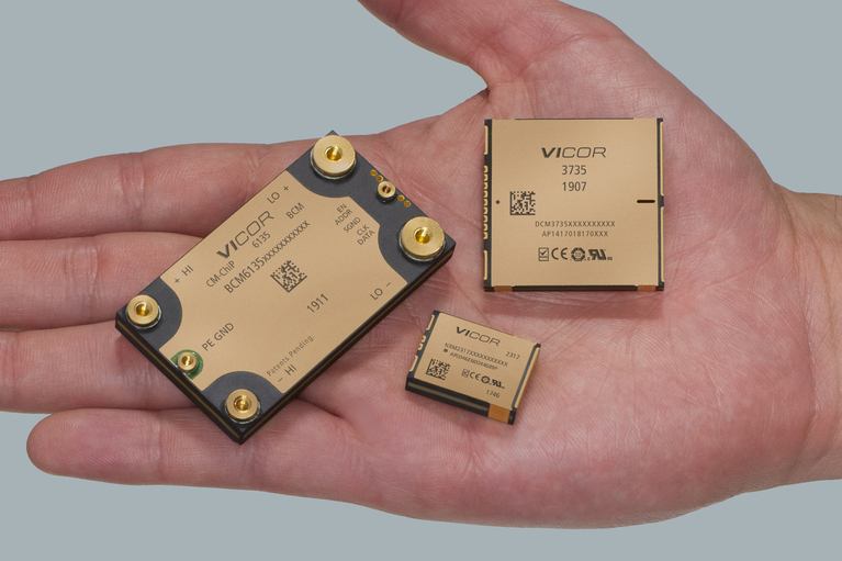 Image of Vicor products in hand: BCM6135, DCM3735, and NBM2317