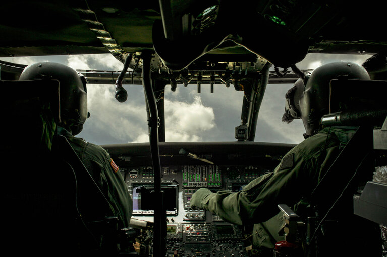 Image of two soldiers seated in a cockpit